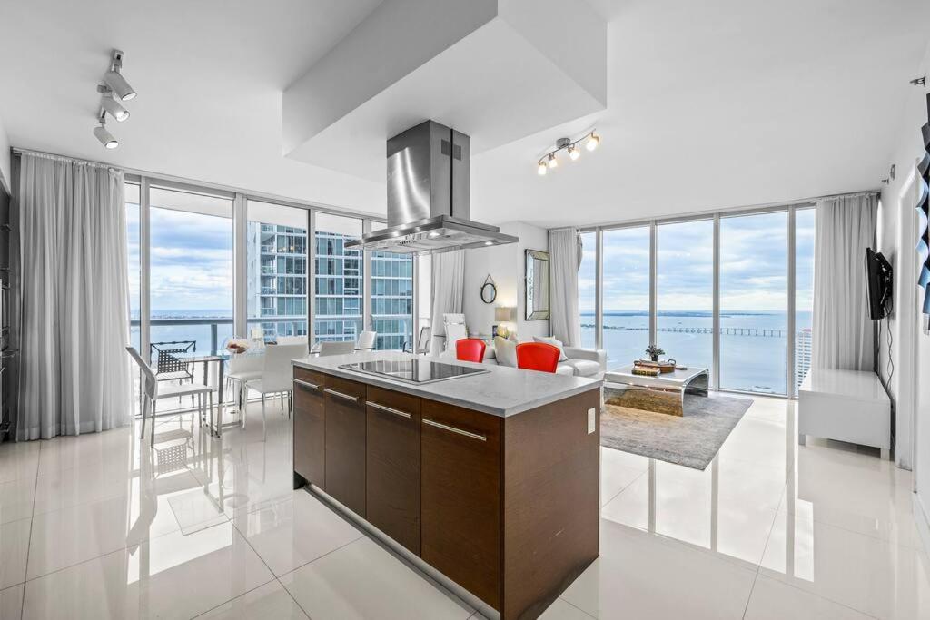 a kitchen and living room with a view of the ocean at 44th FLOOR CORNER 2 BDR• ICON BRICKELL• OCEAN VIEW AND FREE SPA in Miami