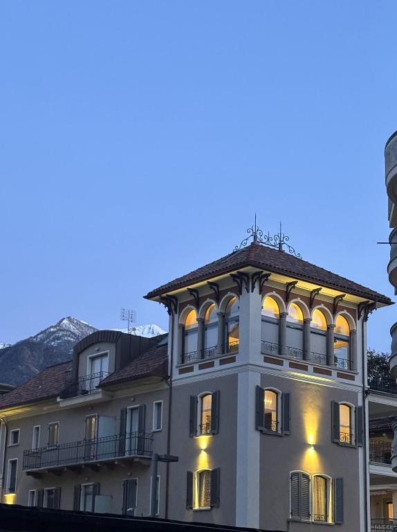 a large white building with lights on at Residenza la Torretta in Domodossola