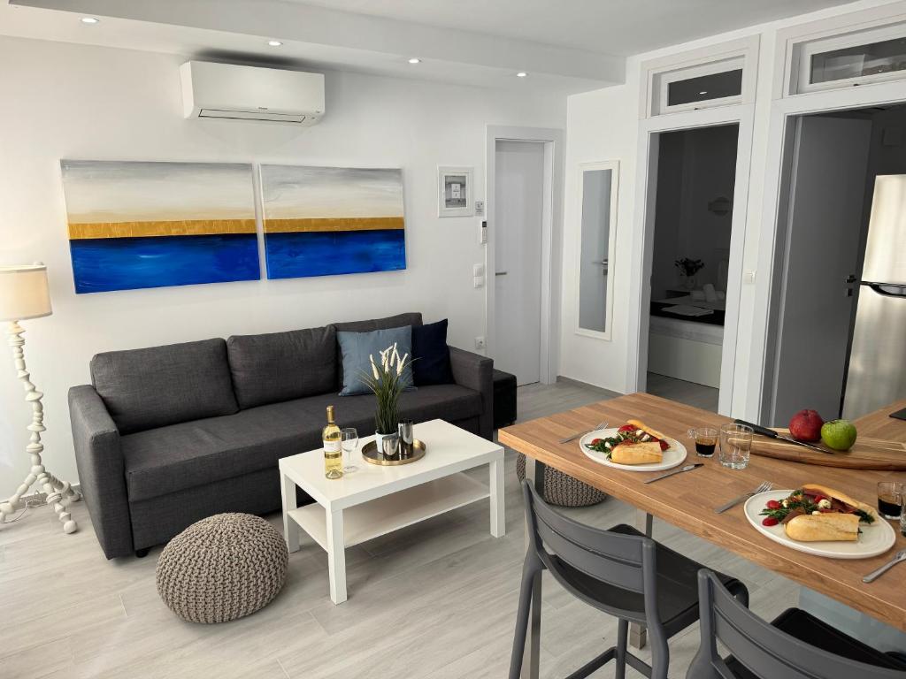 a living room with a couch and a table at Central Suites Aegina 3 in Egina