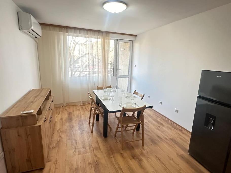 a kitchen with a table with chairs and a refrigerator at 20% Discount! Central Seaside in Varna City