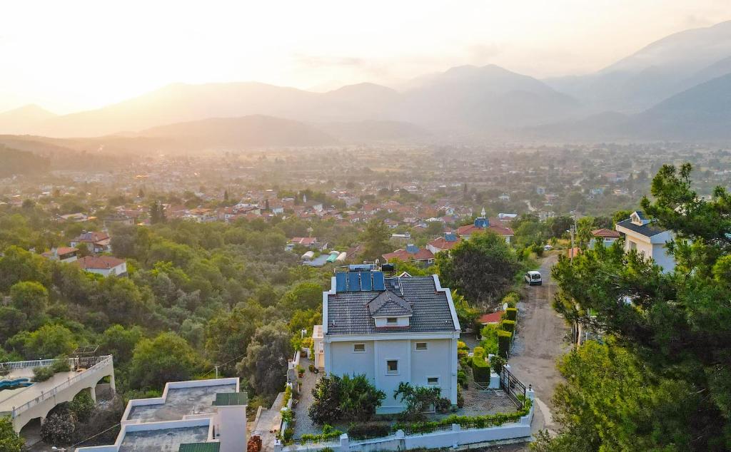 a house in a city with mountains in the background at Villa Bianca in Fethiye