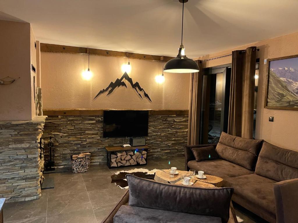 a living room with a couch and a fireplace at APARTAMENT KAUKAZ in Szczawnica