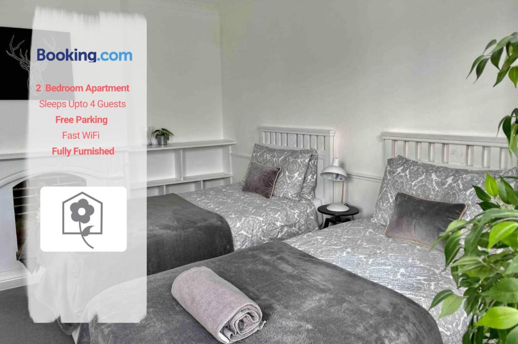 two beds sitting next to each other in a room at Netley Village Apartment By Your Stay Solutions Short Lets & Serviced Accommodation Netley Southampton With Free Wi-Fi in Southampton