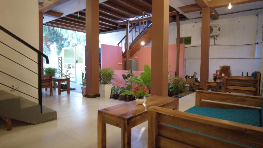 a lobby with tables and chairs and a unintention at The Point Bay in Arugam Bay