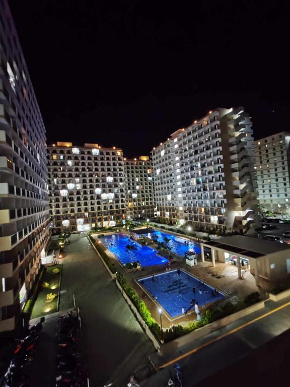 a view of a city at night with two pools at New Cozy Studio Apartment in Marigondon