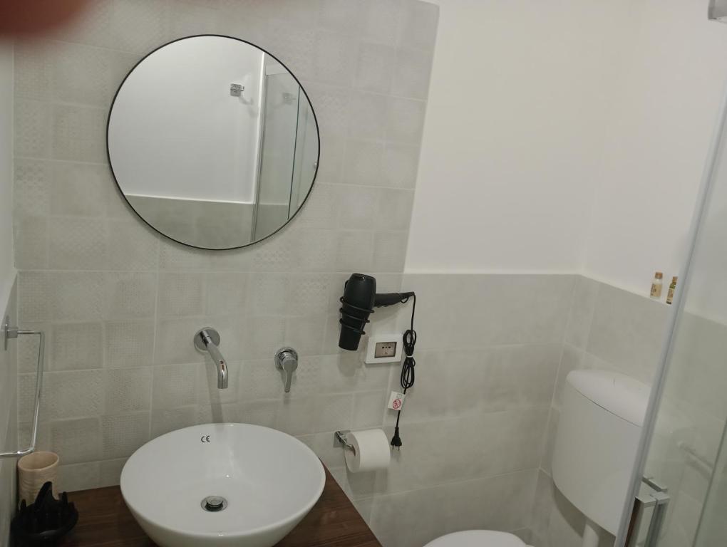a bathroom with a white sink and a mirror at Calatafimi Rocca Home in Palermo