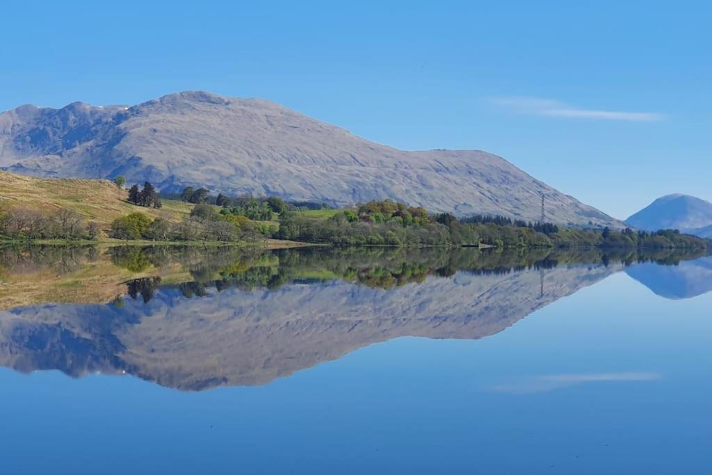 a reflection of a mountain in a lake at Loch Awe Cabin, Portsonachan, near Dalmally in Portsonachan