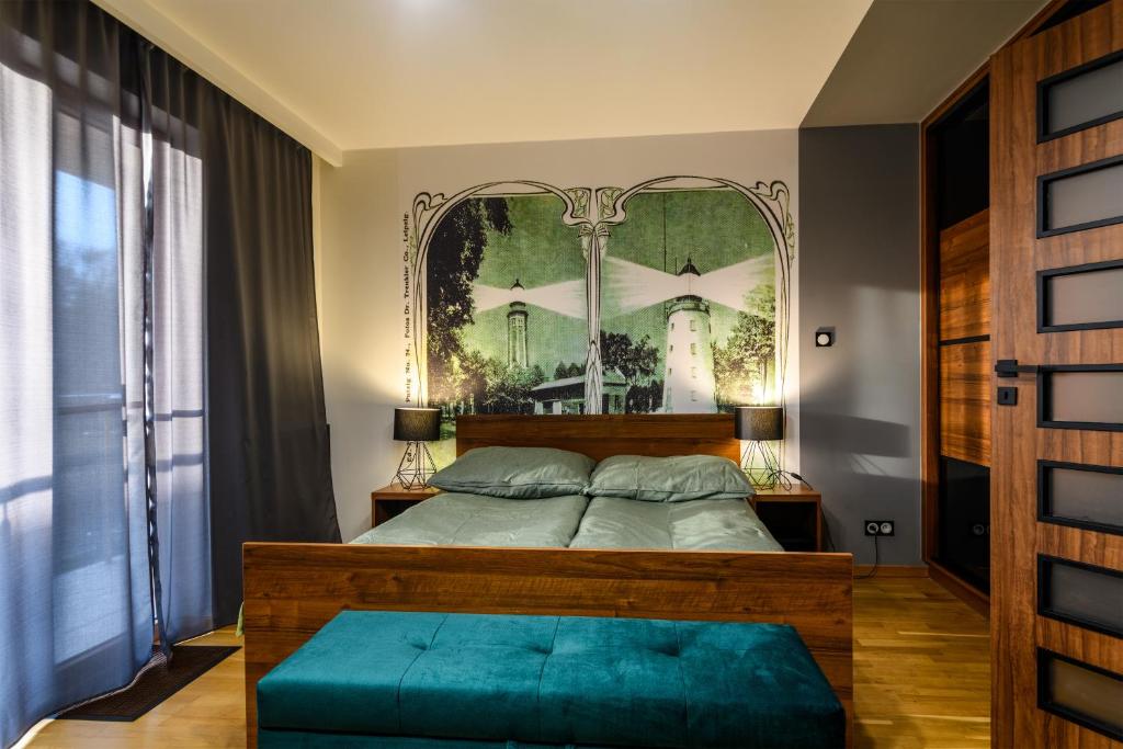 a bedroom with a bed with a large mirror at Apartament Morska Przygoda in Jastrzębia Góra