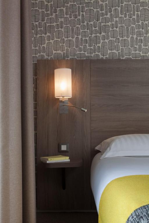 Postel nebo postele na pokoji v ubytování Logis Hôtel Beauséjour Colmar