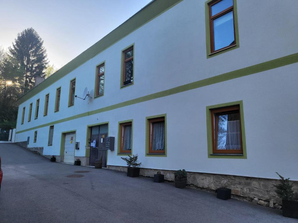 a white building with windows on the side of it at Appartement Purzel in Mauerbach