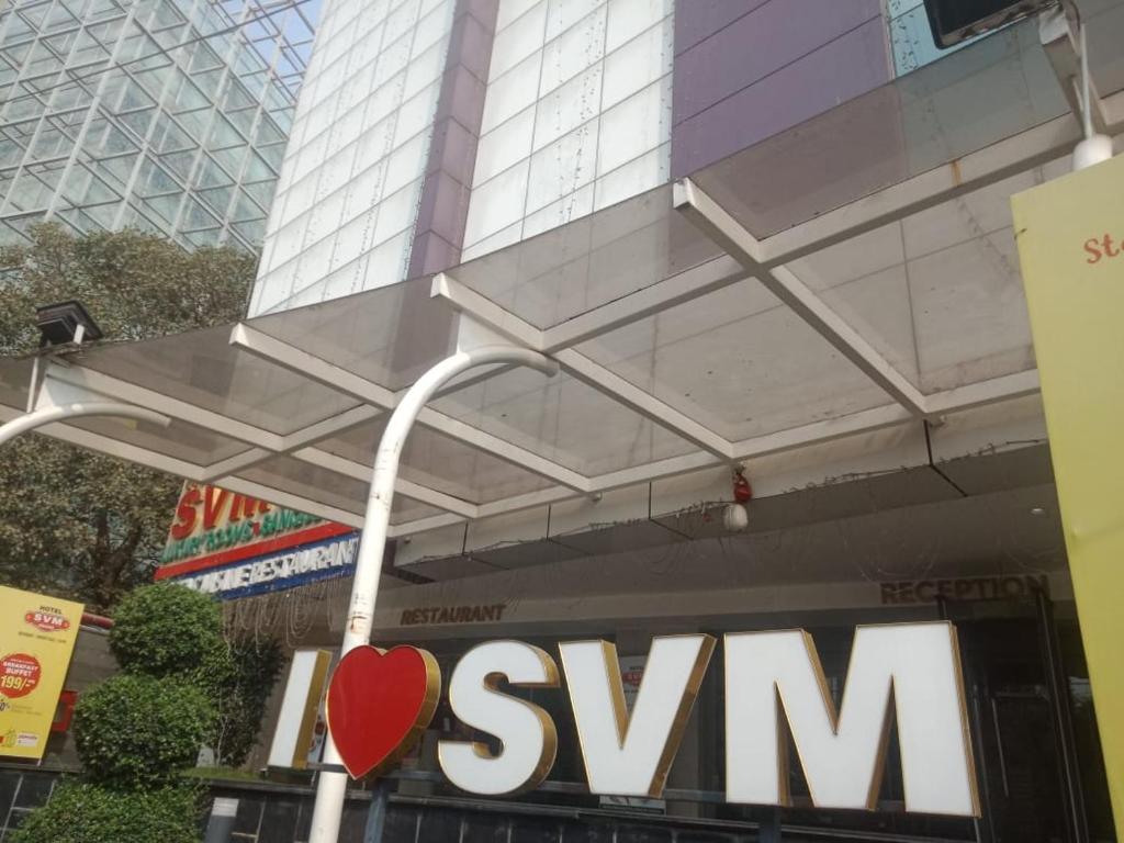 a sign for the company ofswm in front of a building at Hotel Svm Pride Banjara-Hot Live Counter-Road View Stay- Free Lavish Buffet Breakfast-18 Percent Off In Restaurant Food Order in Hyderabad