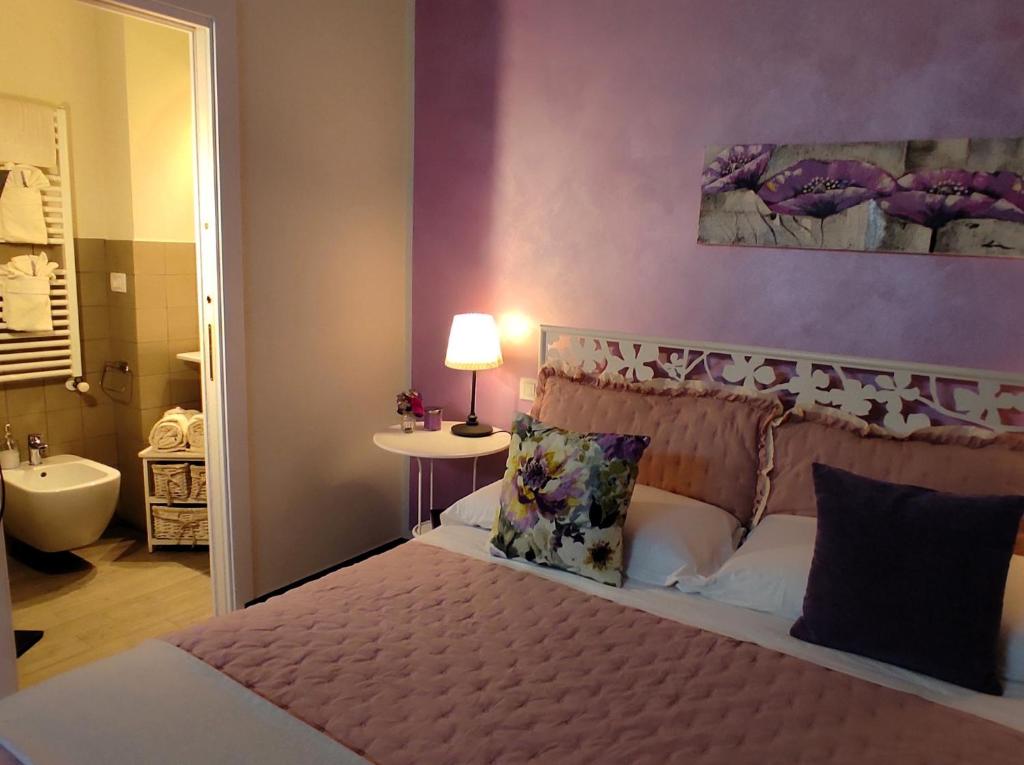Postel nebo postele na pokoji v ubytování Affittacamere Casa Mac & Rose