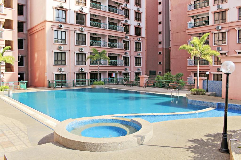 a large swimming pool in front of a building at Marina Court Kota Kinabalu-2Bedroom 2Bathroom & 3 Bedroom 2 Bathroom Apartment in Kota Kinabalu