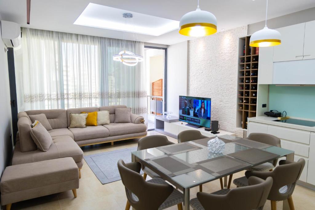 a living room with a couch and a table at Luxury Lungomare apartament in Vlorë