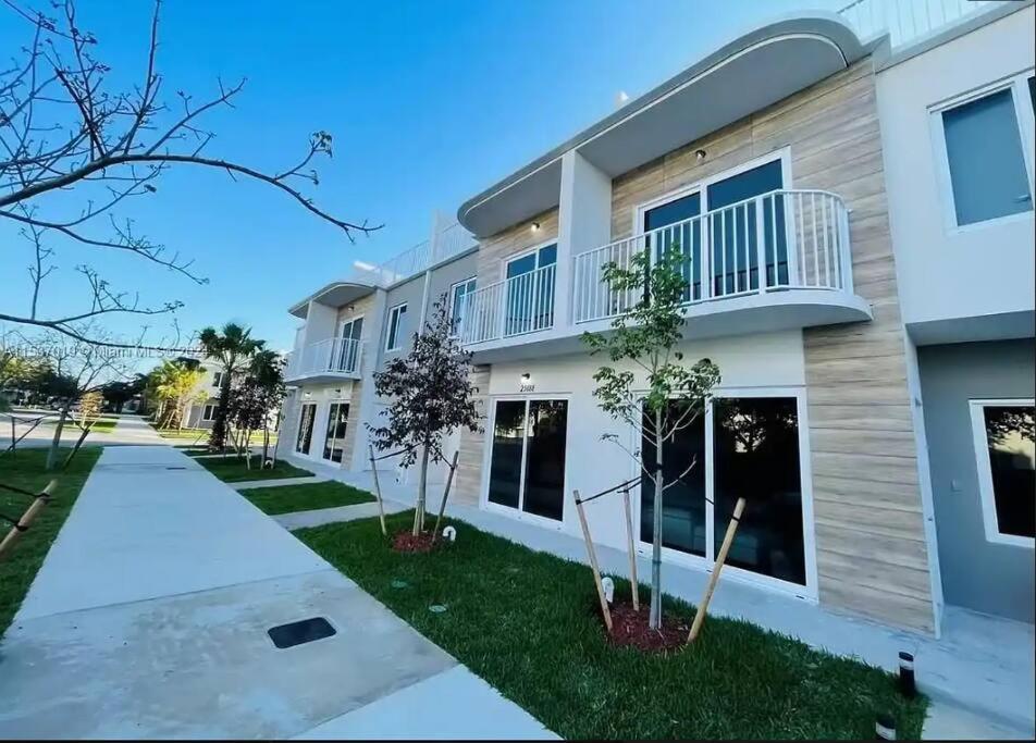 a large apartment building with a balcony at NEW 3 Story in Homestead- 3/2.5 Balcony & Rooftop in Homestead