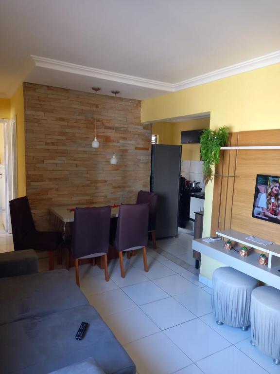 a living room with a table and chairs at Vog João de Goes in Ilhéus