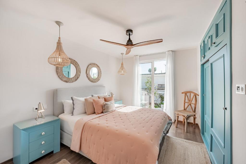 a bedroom with a bed and a blue cabinet at La Familia Beach House La Cala in La Cala de Mijas