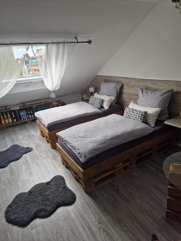 a bedroom with two twin beds and a window at Schlafgut24 2 in Dortmund