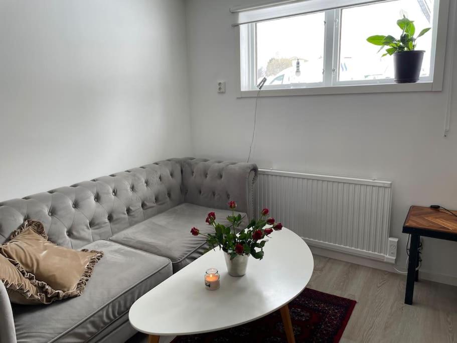 a living room with a couch and a table at A new apartment close to City in Boden