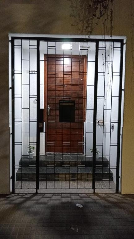 a door in a building with a gate in front at La Plata 1643 in La Plata