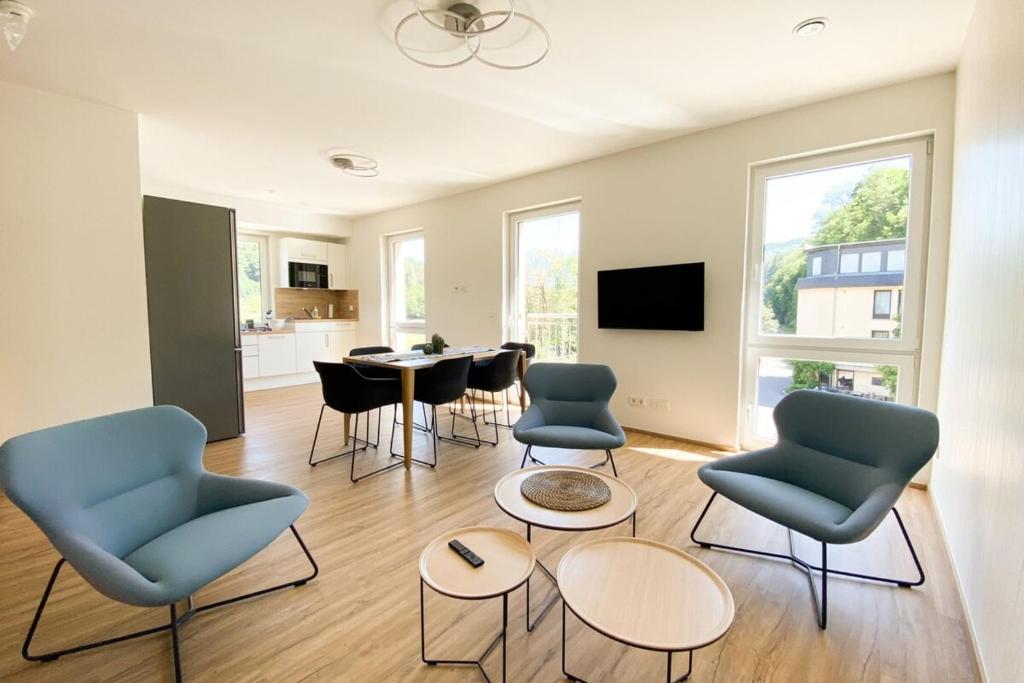 a living room with chairs and a dining room at 110 Lux Furnished flat in Beaufort