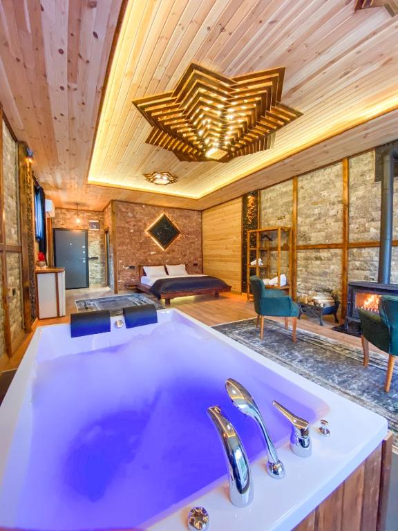 a bathroom with a large tub in a room at Dayf Suit Naliya Otel in Çamlıhemşin