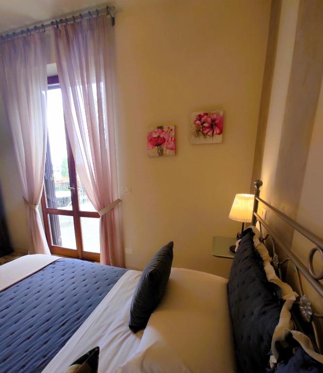 Postel nebo postele na pokoji v ubytování Affittacamere Casa Mac & Rose