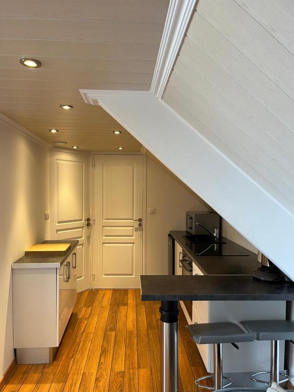 an attic kitchen with a staircase in a house at Intra Muros Vue Mer in Saint Malo