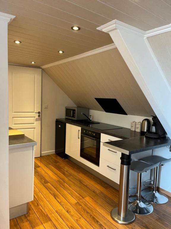 a kitchen with a black counter top in a attic at Intra Muros Vue Mer in Saint Malo