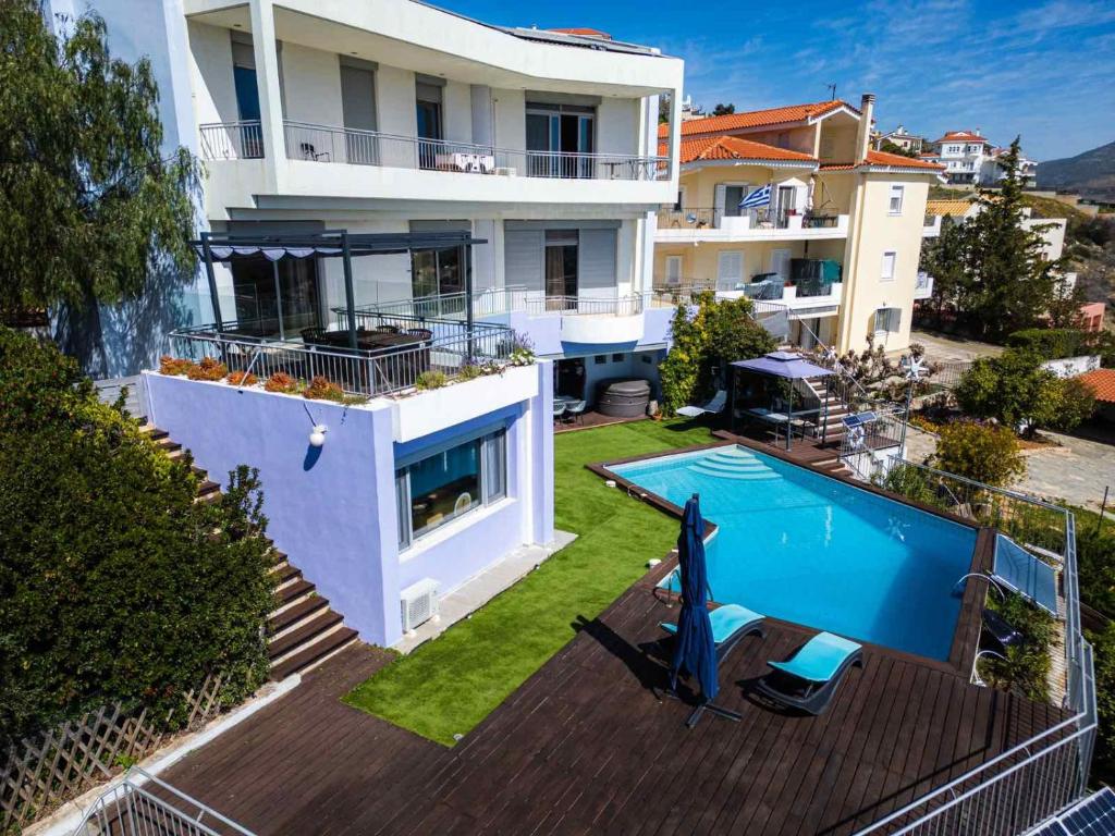 an aerial view of a house with a swimming pool at Reunion in Greece Villa in Drafí