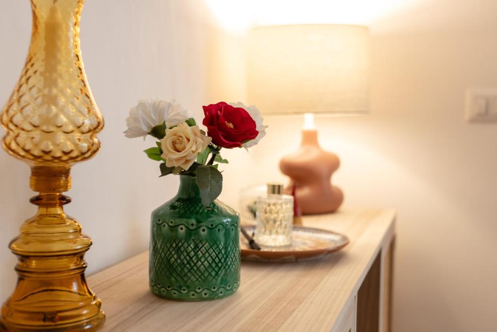 a green vase with flowers sitting on a table at Casa Venturo in Minori