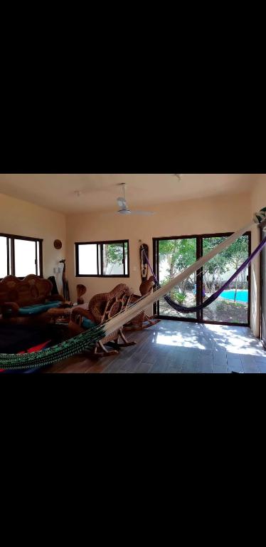 a living room with large windows and a couch at Villa luna y sombra in Tulum