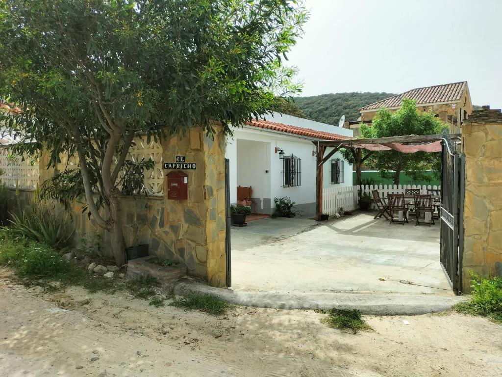 ein Haus mit einem Baum und einer Terrasse in der Unterkunft El Capricho in Benalup Casas Viejas