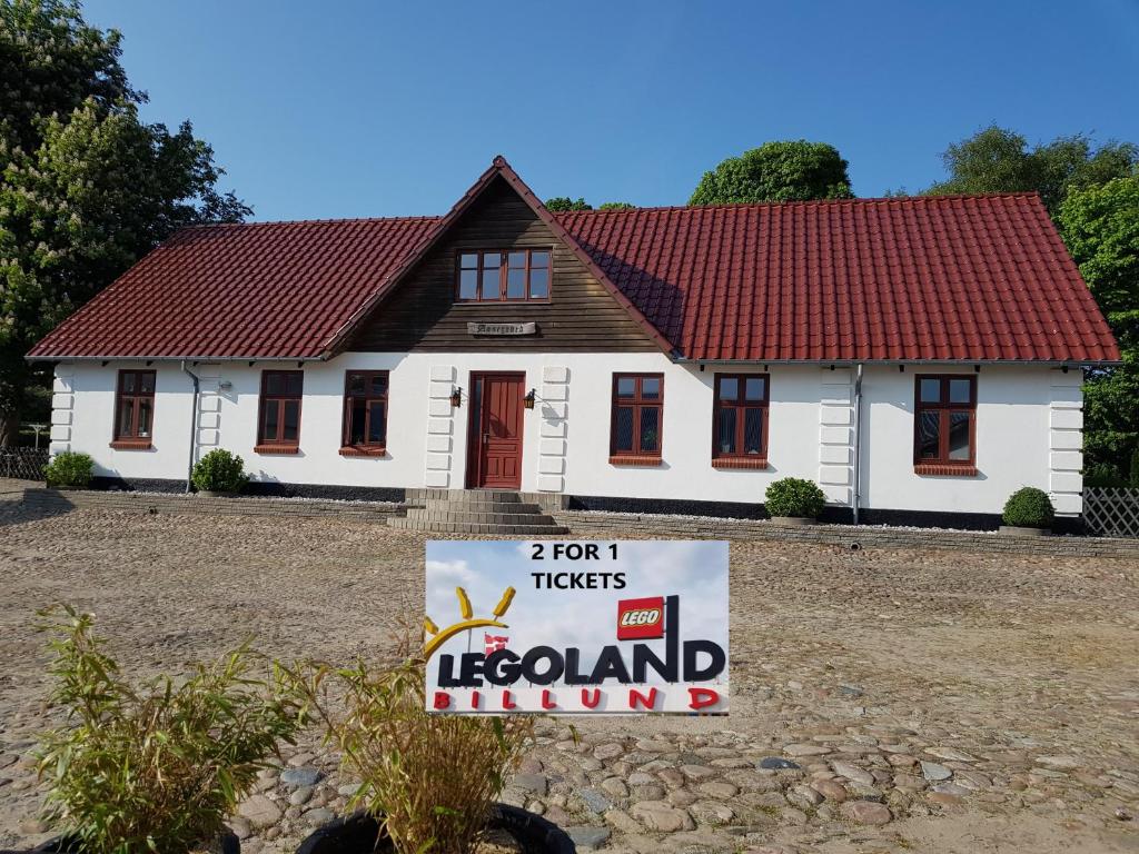 a house with a sign in front of it at STAY Billund in Vandel