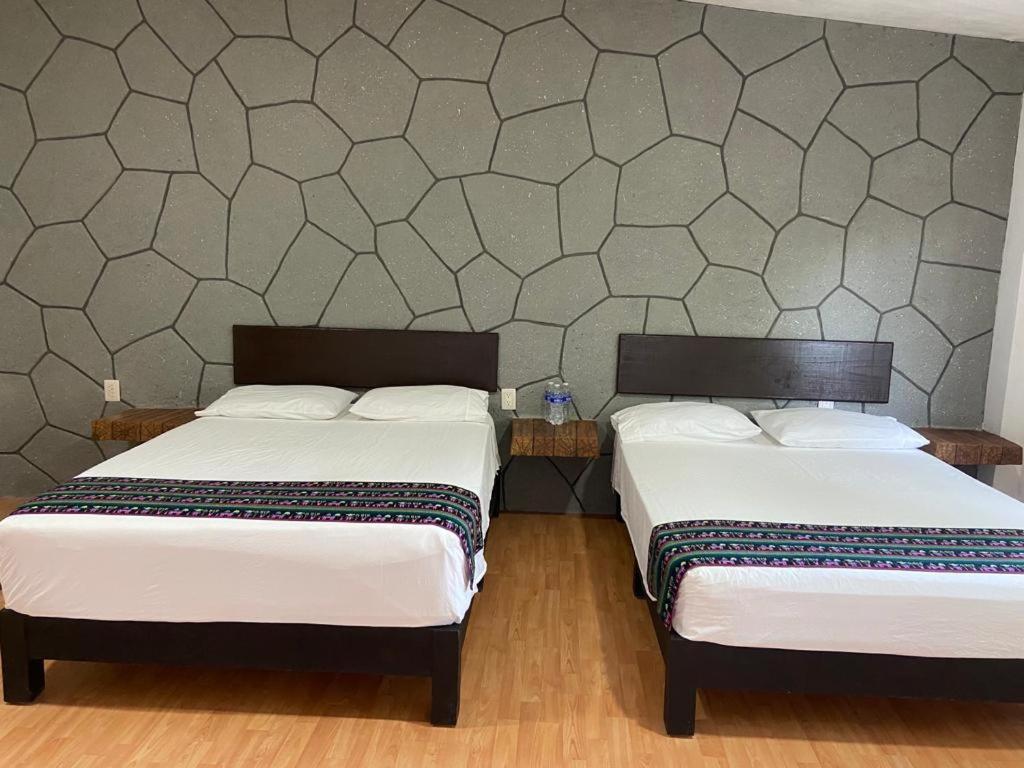 Postel nebo postele na pokoji v ubytování Tonantzincalli SPA Prehispanico