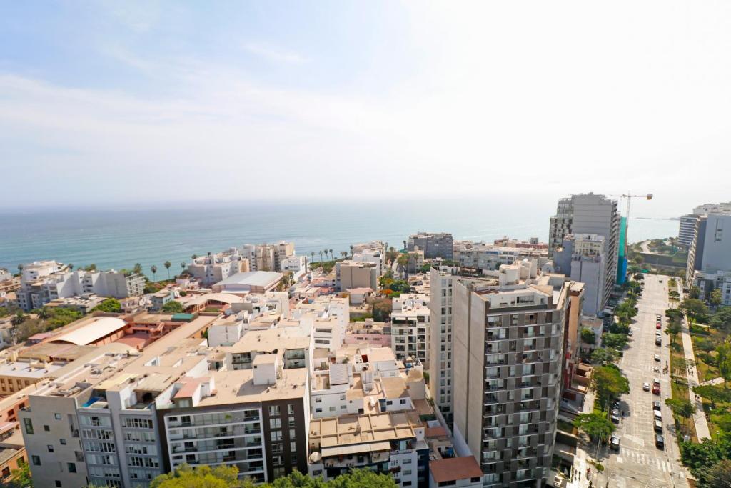 an aerial view of a city with buildings and the ocean at Beautiful floor 9th apartment Pool Gym Barranco in Lima
