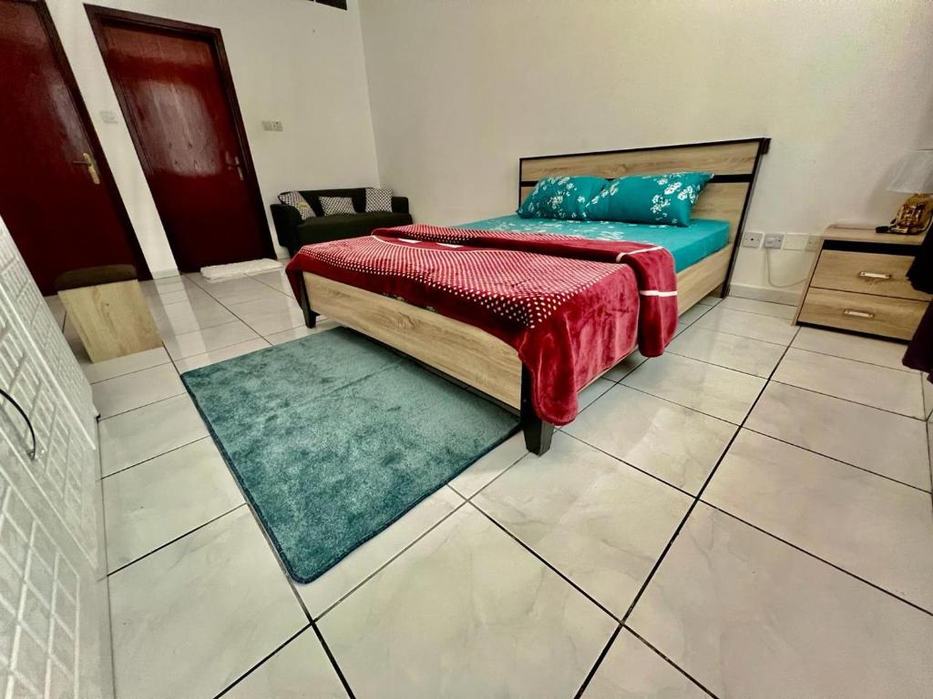 a bedroom with a bed and a green rug at Luxury Awaits: Master Bedroom for Rent! Indulge in comfort and style. in Sharjah