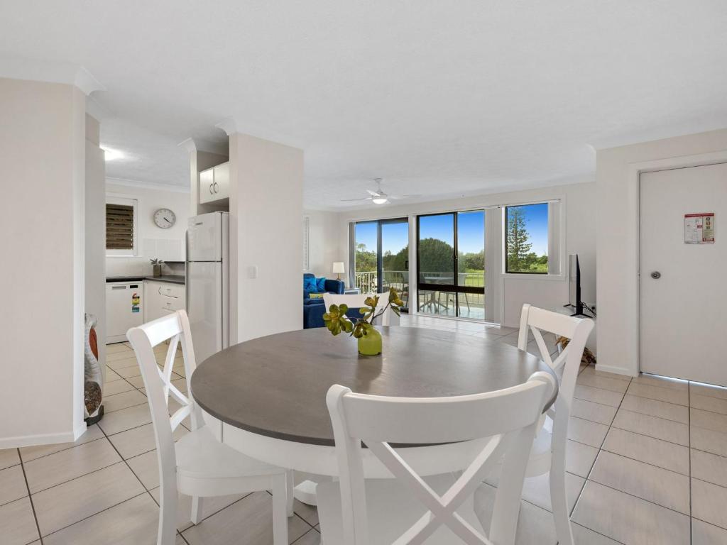 a kitchen and dining room with a table and chairs at Ocean Outlook on Marine Parade in Kingscliff