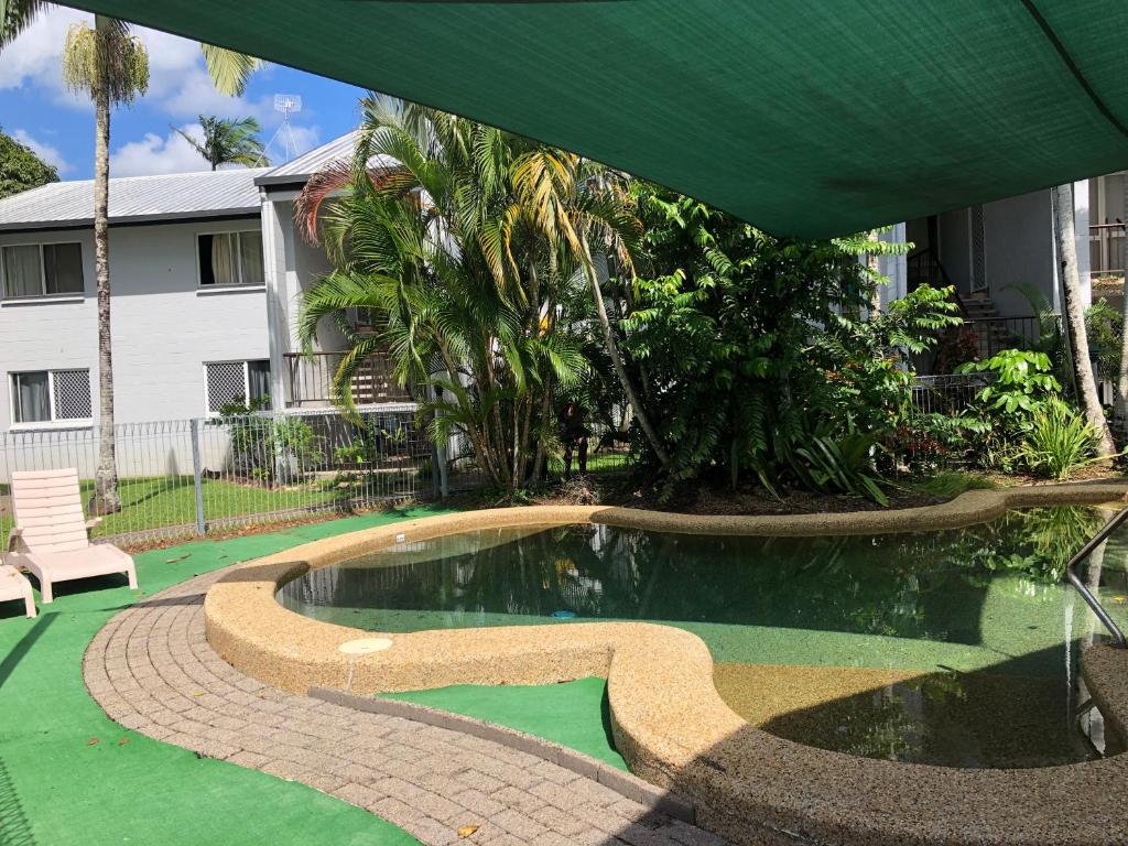 a swimming pool in the middle of a yard at Coral Reef Resort in Cairns
