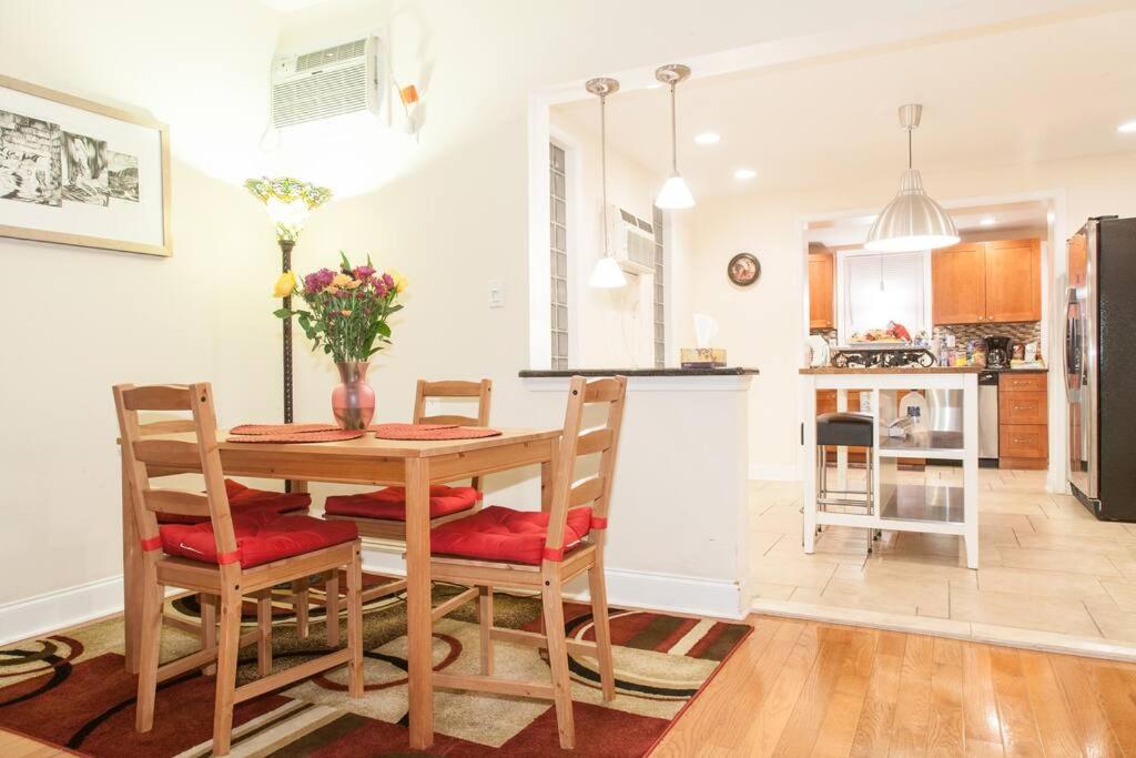 a kitchen and dining room with a table and chairs at Spacious Passyunk Square 3BR House in Philadelphia