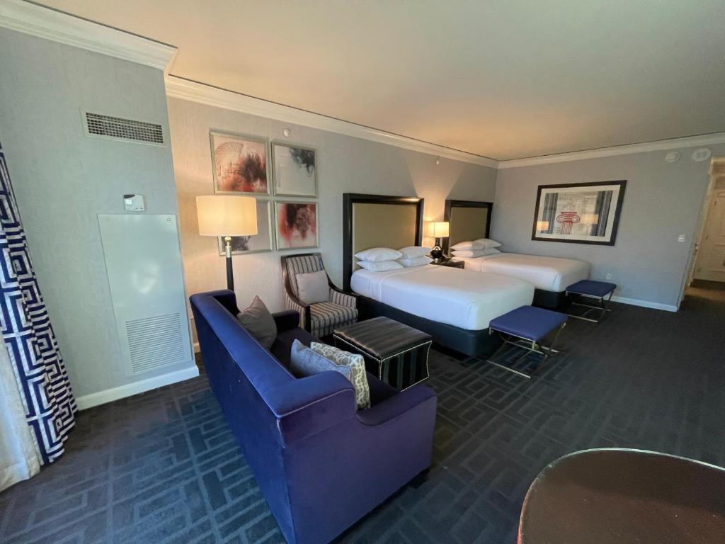 a hotel room with a bed and two chairs at Cozy Unit by Caesars Atlantic City in Atlantic City