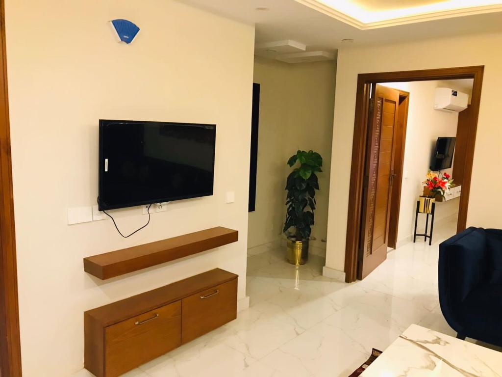 ein Wohnzimmer mit einem Flachbild-TV an der Wand in der Unterkunft 2 bhk apartment available in Al qasmiyah Sharjah in Schardscha