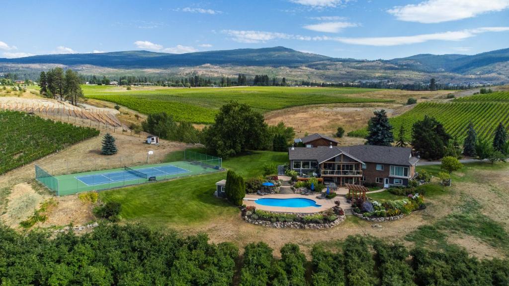 an aerial view of a estate with a tennis court and a house at Crawford View in Kelowna