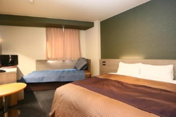 Postel nebo postele na pokoji v ubytování Hotel New Shizuoka