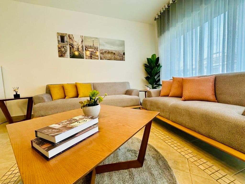 een woonkamer met een bank en een salontafel bij Abdoun Place in Amman
