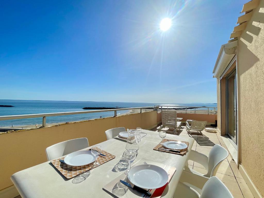 une table et des chaises sur un balcon avec vue sur l'océan dans l'établissement Appartement 2 pièces avec terrasse 25m² et parking à 50m de la plage - FR-1-338-114, à Sète