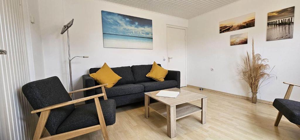 a living room with a couch and a table at Wohnung-A-303 in Böhl