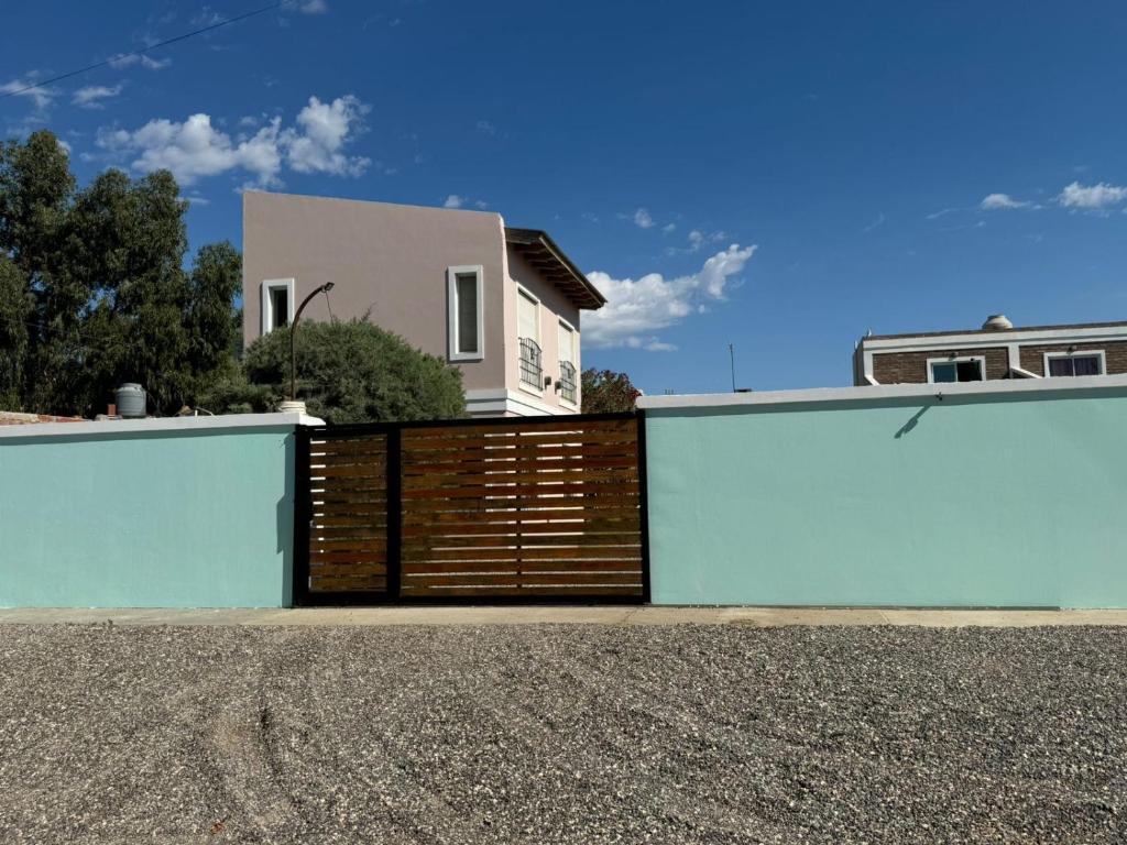 a fence in front of a house at Caleta del Sur in Las Grutas