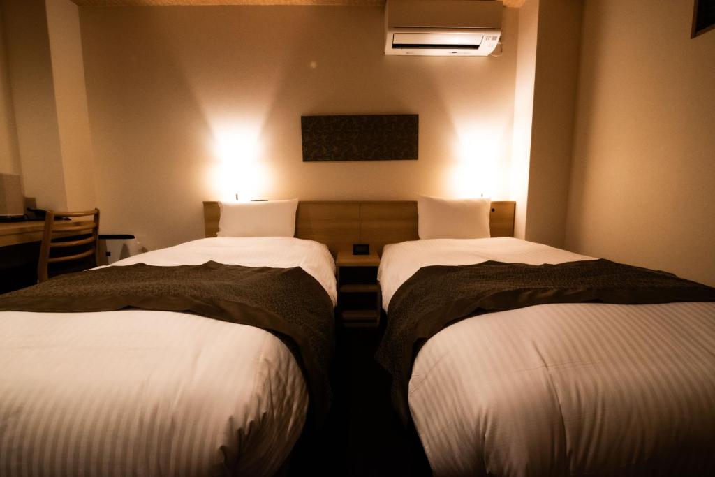 Postel nebo postele na pokoji v ubytování Xcellent Hotel