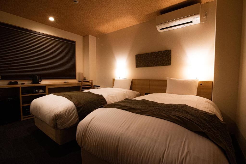 Postel nebo postele na pokoji v ubytování Xcellent Hotel